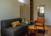 Thumbnail 3 of 9 - a living room with a couch and a table
