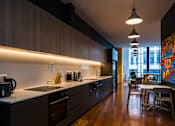Thumbnail 17 of 18 - a kitchen and dining area in a modern apartment
