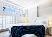 Thumbnail 19 of 20 - a bedroom with a large bed and a window