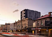 Thumbnail 11 of 11 - a city street with buildings and a tall building