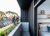 Thumbnail 6 of 14 - a bedroom has a balcony with a view of the city