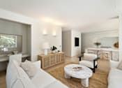 Thumbnail 18 of 24 - A modern living room with white furniture and a large window.
