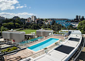 Thumbnail 7 of 24 - A view of a pool and apartment buildings from a high vantage point.