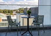 Thumbnail 3 of 10 - a table and chairs on a balcony overlooking a city