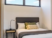Thumbnail 1 of 11 - a small bedroom with a bed and a window