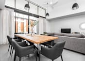 Thumbnail 17 of 19 - a dining room with a wooden table and chairs