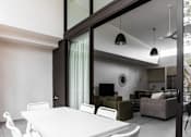 Thumbnail 12 of 19 - a white dining table and chairs in a room with large glass doors