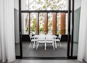 Thumbnail 8 of 19 - a dining room with a table and chairs in front of a window