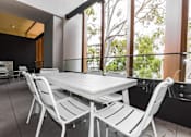 Thumbnail 5 of 19 - a dining area with a table and chairs in front of a window
