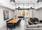 Thumbnail 7 of 19 - the living room and dining area of a modern house with white walls and glass doors
