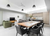 Thumbnail 2 of 19 - a living room and kitchen with a wooden table and chairs