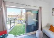 Thumbnail 9 of 11 - a living room with a couch and a sliding glass door