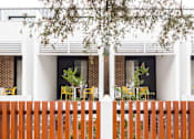 Thumbnail 11 of 11 - the exterior of a house with a fence and tables and chairs