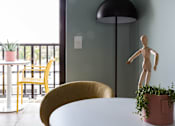 Thumbnail 3 of 11 - a dining room with a table and chairs and a wooden doll