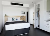 Thumbnail 6 of 13 - a bedroom with a bed and a closet