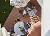Thumbnail 4 of 13 - a deck with a table and chairs and an umbrella
