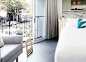 Thumbnail 1 of 13 - a hotel room with a bed and a balcony