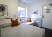 Thumbnail 4 of 11 - a small bedroom with a bed and a window