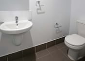 Thumbnail 10 of 11 - a bathroom with a sink toilet and a mirror