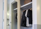 Thumbnail 3 of 11 - a closet with a mirror and a closet door open