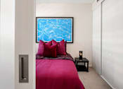 Thumbnail 6 of 22 - a bedroom with a bed and a picture of a pool