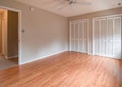Thumbnail 4 of 4 - an empty living room with a wood floor and a ceiling fan
