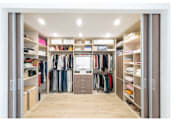 Thumbnail 3 of 11 - Spacious walk-in closet with shelves and center isle