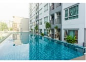 Thumbnail 2 of 11 - Luxurious swiming Pool surrounded with apartment buildings
