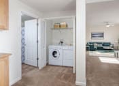 Thumbnail 18 of 21 - A laundry room with a washer and dryer is shown.