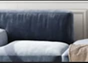 Thumbnail 11 of 11 - a blue chair sitting next to a white wall