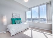 Thumbnail 3 of 8 - a bedroom with a bed and a large window