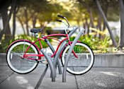 Thumbnail 46 of 48 - A red bicycle is parked on a grey bike rack.