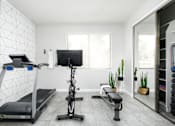 Thumbnail 5 of 9 - A well-equipped home gym with a treadmill, exercise bike, and bench.