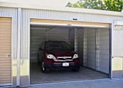 Thumbnail 6 of 13 - a red car is parked in a garage