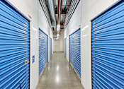 Thumbnail 5 of 13 - a row of closets with blue doors in a hallway