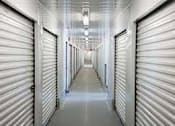 Thumbnail 7 of 13 - a long hallway with closed doors in a prison