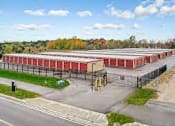 Thumbnail 3 of 13 - an aerial view of a parking lot with red buildings