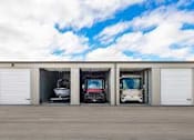Thumbnail 10 of 13 - three cars parked in the front of a garage