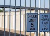 Thumbnail 11 of 13 - two speed limit signs on the side of a fence