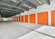 Thumbnail 13 of 13 - the inside of an empty garage with orange doors