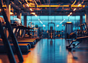 Thumbnail 3 of 7 - A gym with treadmills and exercise machines.