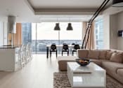 Thumbnail 7 of 20 - A modern living room with a large window overlooking the city at Bluebell Ridge, Denver 80202