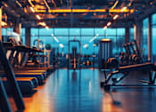 Thumbnail 8 of 10 - A gym with treadmills and exercise machines.