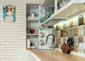 Thumbnail 5 of 5 - A kitchen with a white brick wall and a wooden counter.
