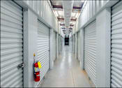 Thumbnail 6 of 22 - an empty warehouse with doors and a fire hydrant