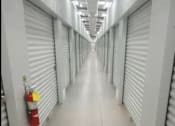 Thumbnail 15 of 22 - an empty hallway with doors and a fire hydrant on the wall