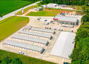 Thumbnail 17 of 22 - an aerial view of several buildings and a parking lot