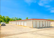 Thumbnail 8 of 22 - a large warehouse building with a car parked in front of it