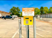 Thumbnail 6 of 9 - a parking meter in a parking lot with a yellow sign