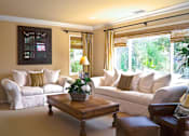Thumbnail 4 of 6 - a living room with couches and a coffee table